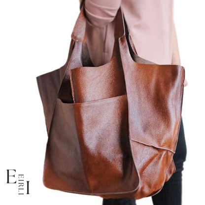 <img src="brown-handbag.jpg" alt=" A beautiful brown handbag carried by a woman official website www.eirlistore.com">