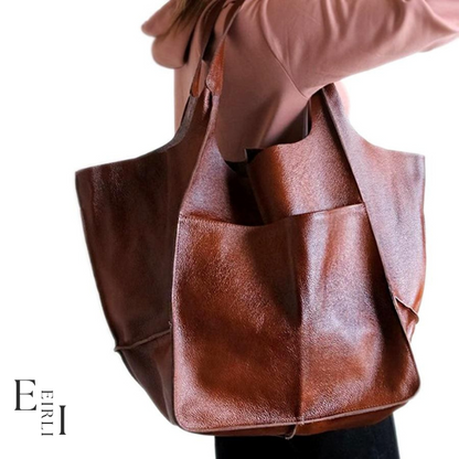 <img src="brown-handbag.jpg" alt=" A beautiful brown handbag carried by a woman official website www.eirlistore.com">