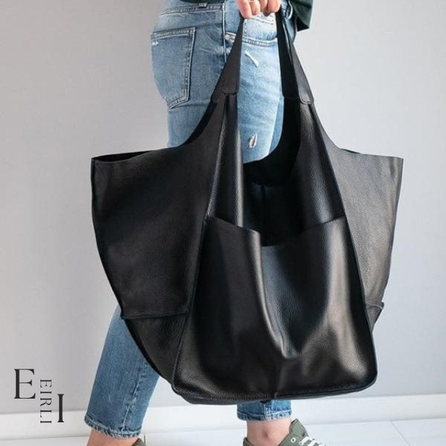 <img src="black-handbag.jpg" alt=" A beautiful black handbag carried by a woman official website www.eirlistore.com">